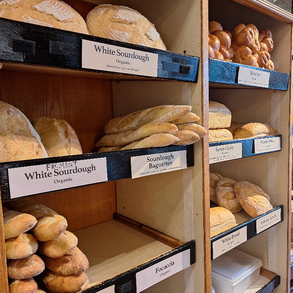 Shelves of sourdough loaves, baguettes and focaccia