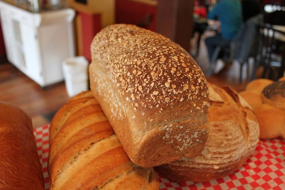 Fresh-baked loaves of bread on a red-checked cloth